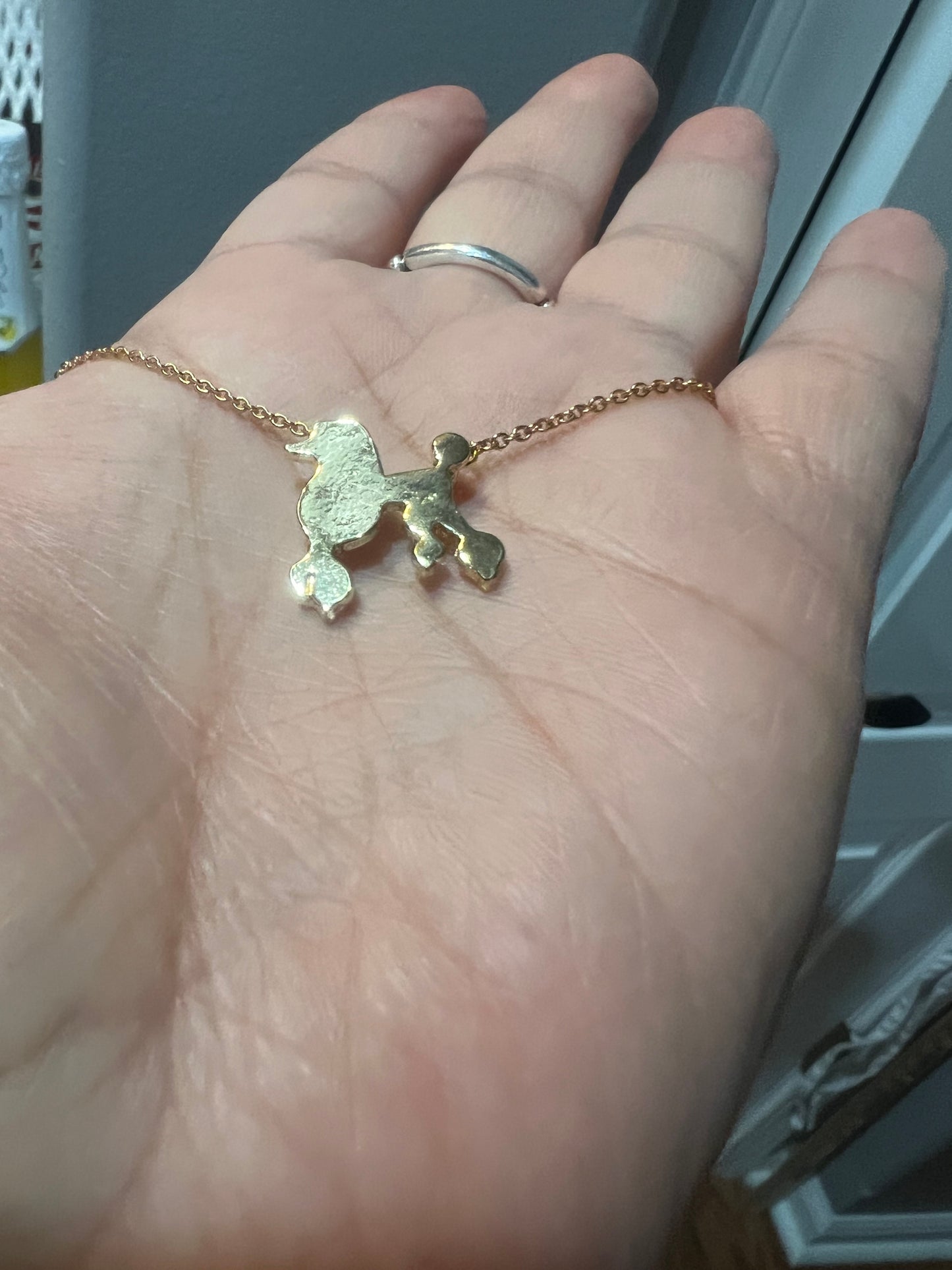 Gold tone poodle necklace