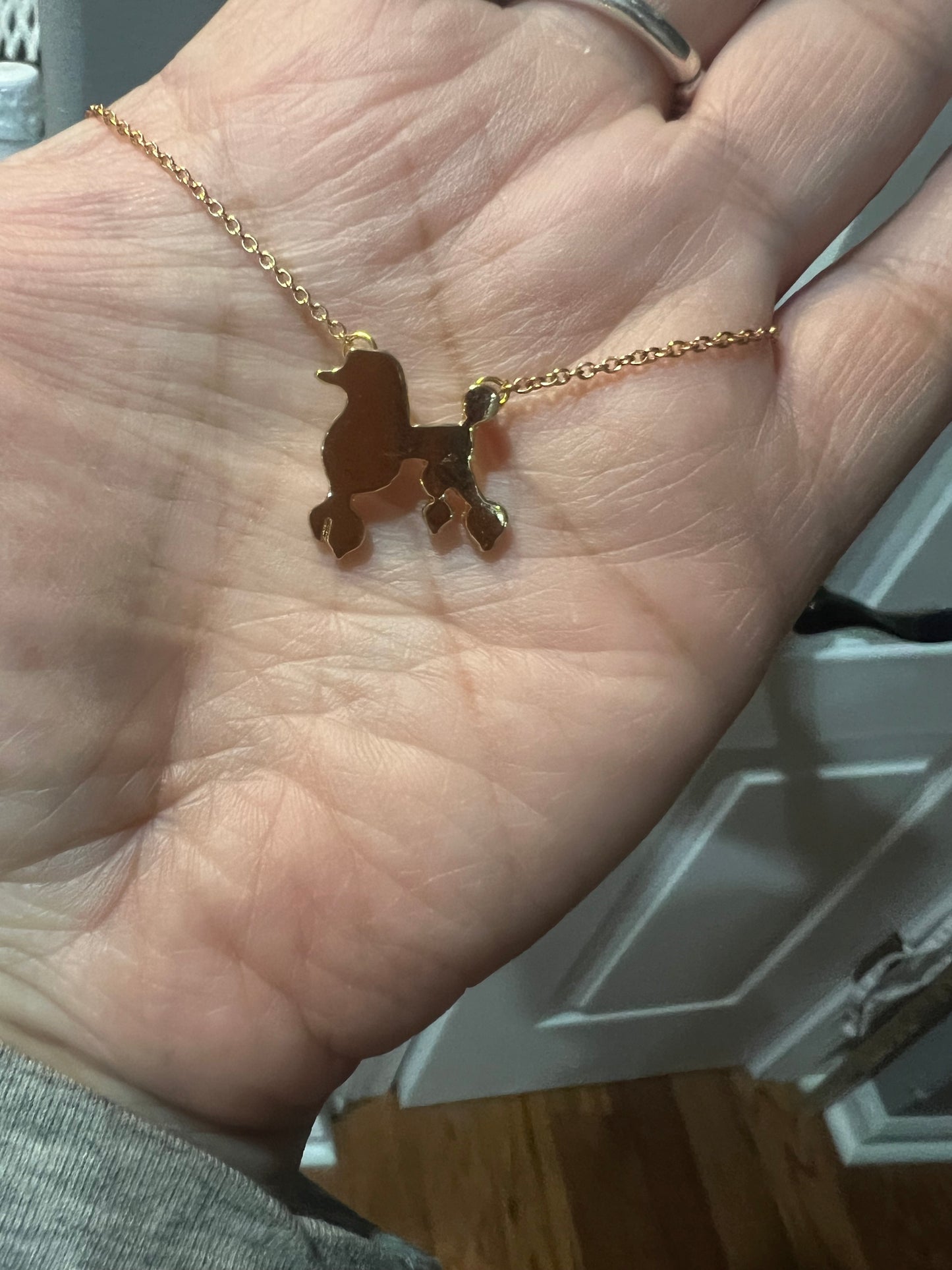 Gold tone poodle necklace